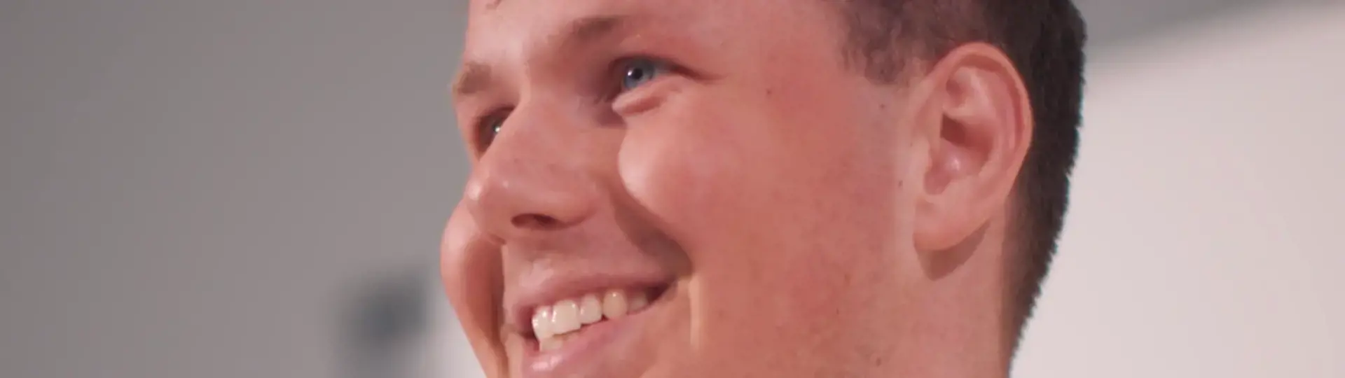 Ung mand smiler og kigger opad